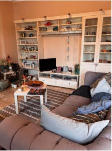 a living room with a couch and a tv at VIAMILANO25 in Mirandola