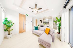 a living room with a couch and a chair at Liber 1 Tachikawa in Tachikawa
