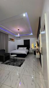 a bedroom with a bed and a living room at TWR Abuja Partner #Blessing in Abuja