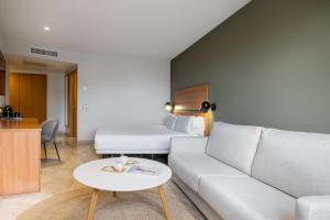 a living room with a couch and a bed at Hotel SB Express Tarragona in Tarragona