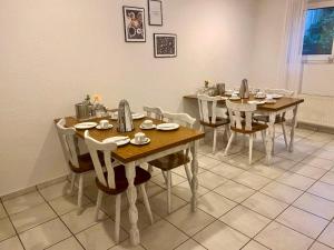 a dining room with wooden tables and chairs at Frühstückspension Stenbrock in Grevenbroich