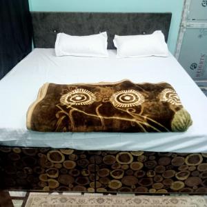 a bed with a drawing of an elephant on it at Hotel THAR in Bikaner
