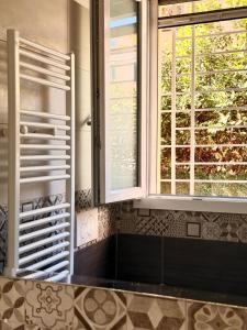 a kitchen with two windows and a counter top at Casa Vacanze Roberta in Follonica +19 photos