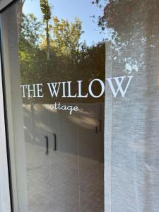 a window with the window exchange sign on it at The Willow Cottage in Oakdale