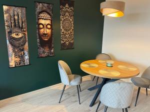 a dining room with a wooden table and chairs at K&T Apartman in Szentendre