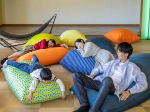 a group of people laying on bean bags on the floor at YU-FURI Nasu-Takao Onsen Lodge in Nasu