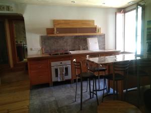 a kitchen with a counter and a sink and a stove at Appartement 48 m2 in Villeneuve-lès-Béziers +5 photos