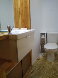 a bathroom with a white sink and a toilet at Appartement 48 m2 in Villeneuve-lès-Béziers