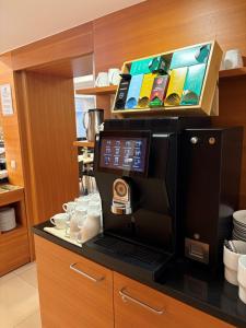 a coffee machine on a counter in a kitchen at Villa Styria - Boutiquehotel mit Sauna und optionaler Halbpension in Bad Aussee