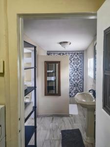 a bathroom with a sink and a mirror at Studio Efficiency Apartment - a peaceful retreat in Port St Lucie in Port Saint Lucie