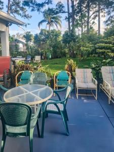a group of chairs and tables on a patio at Studio Efficiency Apartment - a peaceful retreat in Port St Lucie in Port Saint Lucie