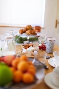 a table with plates of food and other foods on it at Alma ART B&B in Dobrovo +22 photos