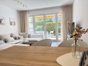 a living room with a table and a couch at Allee 1G - Meerzeit in Dahme