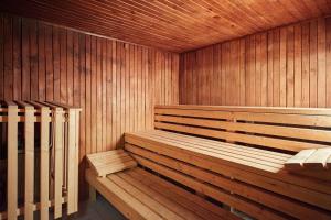 a wooden sauna with a wooden bench in it at OREA Spa Hotel Bohemia Mariánské Lázně in Mariánské Lázně