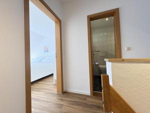 a bathroom with a door leading to a bedroom at Allee 1G - Meerzeit in Dahme +29 photos