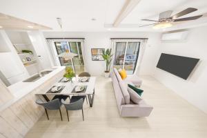a living room with a couch and a table at Liber 1 Tachikawa in Tachikawa