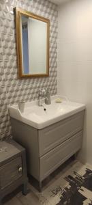 a bathroom with a sink and a mirror at La belle étape in Montbrison