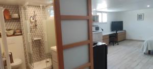 a room with a kitchen and a bathroom with a toilet at La belle étape in Montbrison
