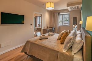 a large bed in a room with a green wall at Villa Decimum in Ciampino