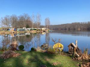 a view of a lake with a bunch of objects on it at Nr 5 Camping Pod mit Terrasse und Seeblick in Langenbernsdorf