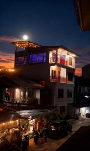 a building with a car parked in front of it at night at Toraja Hikari Homestay in Rantepao +24 photos