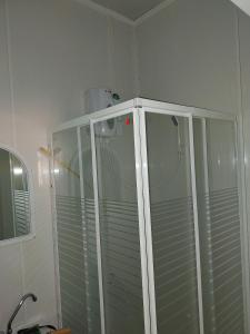 a shower in a corner of a bathroom at Tauber RadApart Kreativhof in Creglingen +34 photos