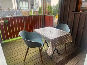 a table and two chairs on a deck at FeWo Sonne in Konstanz
