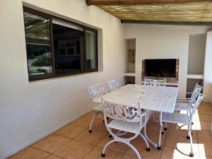 a dining room with a table and chairs at Whale Watch Cottage in St. Helena Bay