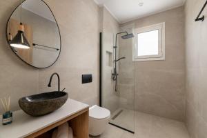 a bathroom with a sink and a shower at Onar -Quiet Luxury Suites with Private Jacuzzi-Ideal for Couples in Archangelos