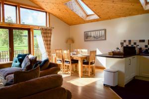 a living room with a couch and a table at Apple Tree Lodge in Errol