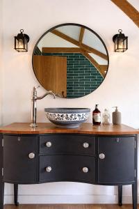 a bathroom with a sink and a mirror at Woolladon Hall in Meeth +18 photos