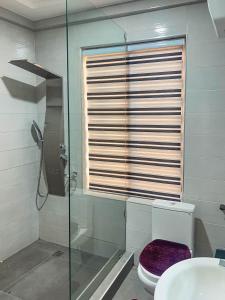 a bathroom with a glass shower and a toilet at Christianborg in Trofwi