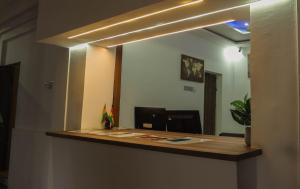 a reception desk in a room with a mirror at Christianborg in Trofwi +3 photos