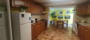 a kitchen with a white refrigerator and a table at Apartmán Víťazov in Trenčín