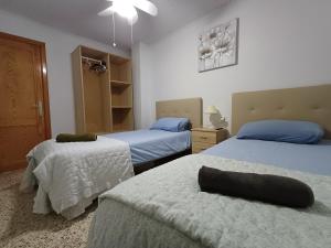a bedroom with two beds with white sheets at PARRA HOME y Garaje, Algemesi Home in Algemesí