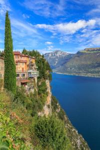 a town on a cliff next to a body of water at Casa Liver Pieve in Tremosine Sul Garda