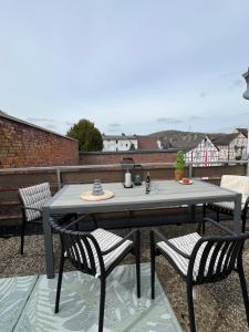a table and two chairs on a patio at Marktplatzapartment 3 in Höxter