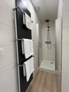 a bathroom with a shower and white towels at Marktplatzapartment 3 in Höxter +13 photos
