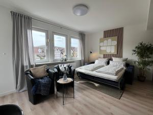 a bedroom with a bed and a couch and a table at Marktplatzapartment 3 in Höxter