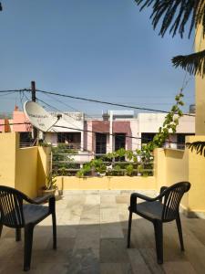 two chairs sitting on top of a balcony at RS Homestay in Bareilly