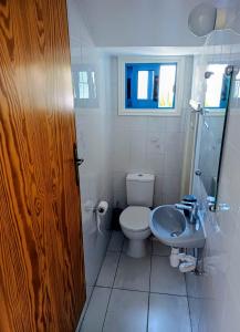 a bathroom with a toilet and a sink at Latchi Holiday House in Prodhromi +20 photos