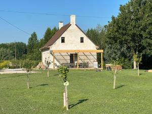 a large white house with trees in a field at La Houblonnière Eperlecques Gite d'Ecou in Tilques