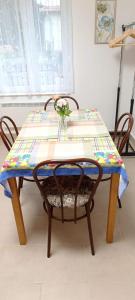 a table with a chair with a quilt on it at Báránykő Apartman in Pásztó +17 photos