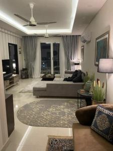 a large living room with couches and a ceiling fan at Comfort Family Villa Islamabad in Islamabad