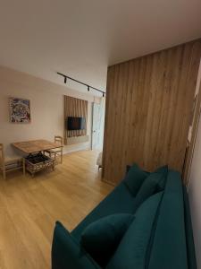 a living room with a couch and a table at Coral Studio Apartment in Shëngjin