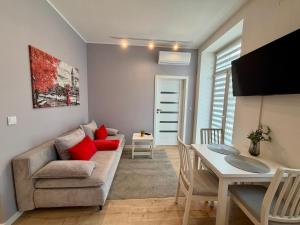 a living room with a couch and a table at Apartment Targowa L9 in Lublin