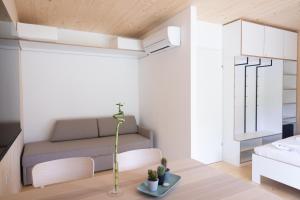 a living room with a couch and a table at MICAMPA Wien Wienerwald in Vienna