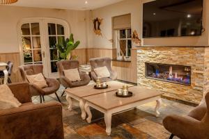 a living room with a table and a fireplace at De Sterre in Losser