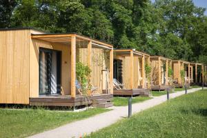 a row of wooden houses in a park at MICAMPA Wien Wienerwald in Vienna