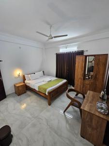 a bedroom with a bed and a table at Nest Mountain Munnar in Munnar